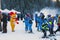 Young skiers preparing to ski and Mouse in Costume