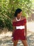 Young skinny Black woman red knit dress