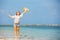 Young skinny caucasian girl at the beach waving