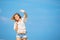 Young skinny caucasian girl waving with blue sky