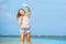 Young skinny caucasian girl waving with blue sky