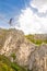 Young slackliner man balancing on a slackline betweend two rocks. Highline with a beautiful natural landscape behind