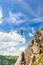 Young slackliner man balancing on a slackline betweend two rocks. Highline with a beautiful natural landscape behind