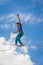 Young slackliner man balancing on a slackline betweend two rocks. Highline with a beautiful natural landscape behind