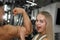 Young slender attractive girl with a cute face groping the muscular athlete for the biceps