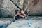 Young slender climber climbs a rock