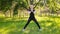 A young, slender woman in a sports uniform does a lunge exercise to train the muscles of the legs. Fitness classes in nature