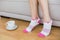 Young slender woman wearing pink socks