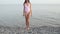 Young slim beautiful woman on beach, dancing, summer, having fun, positive mood,