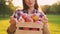 Young slim blurry woman in casual wear gives a wooden crate