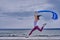 Young slim brunette woman jumping while jogging while holding a blue scarf in her hands. A woman is engaged in gymnastics in the s