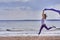 Young slim brunette woman jumping while jogging while holding a blue scarf in her hands. A woman is engaged in gymnastics in the s