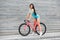 Young slim sportive woman on bicycle