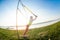 Young slim  woman doing suspension training with fitness straps outdoors near the lake at daytime. Healthy lifestyle