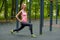 Young slim woman doing workout on training ground