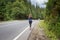 Young slim woman jogging in mountains. Rear view