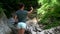 Young slim woman is taking selfies by smartphone in nature, traveler is photographing