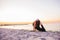 Young slim yogi woman doing Urdhva Mukha Svanasana or Upward Facing Dog Pose against sunset on the beach. Healhy lifestyle concept