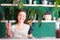 Young smile woman shows dehydrated crisps in vegan shop