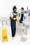 young smiling african american cleaners with cleaning equipment