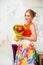 Young smiling beautiful woman with a bouquet of flowers at the birthday. Portrait in a cafe