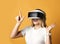 Young smiling blonde woman is happy to explore virtual augmented reality wearing vr glasses. Woman in cyber space.