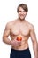 Young smiling bodybuilder holding apple.