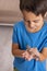 A young smiling boy holds a lizard in his hand at home.    The concept of a happy childhood.  Children`s hobbies