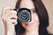 Young smiling brunette girl with camera