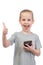 Young smiling caucasian boy with mobile phone shows thumbs up