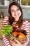 Young smiling caucasian housewife with shopping bag