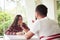 Young smiling couple is chatting in cozy sunlit room