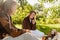 Young smiling couple in love enjoying picnic time in park