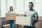 Young Smiling Couple Packing Cardboard Boxes