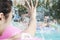 Young smiling family splashing and playing in the pool