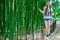 Young and smiling girl with long hair stands near a high bamboo