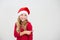 Young smiling, girl in santa hat show with index finger isolated on white background. Kid point. Christmas advertising concept,