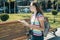 Young smiling girl student with city map and camera, female traveling on a summer sunny day