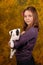 Young smiling girl with white bullterrier puppy.