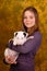 Young smiling girl with white bullterrier puppy.