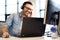 Young smiling male call center operator doing his job with a headset.Portrait of call center worker at office.