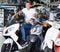 Young smiling man purchaser sitting on the bike in the shop