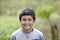 Young smiling mixed race boy in woods