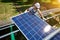 Young smiling mounter installing innovative modern solar panels.