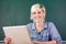 Young Smiling Teacher With Laptop At School