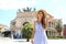 Young smiling tourist woman in Palermo with Politeama Theatre on the background. Attractive traveler girl visiting Sicily on