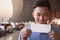 Young Smiling traveler looking at ticket at airport