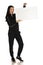 Young smiling woman in black track suit holding empty white board on white