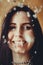 Young smiling woman celebrates mardi gras close-up portrait with confetti