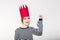 Young smiling woman celebrating party, wearing stripped dress and red paper crown, happy dynamic carnival disco ball